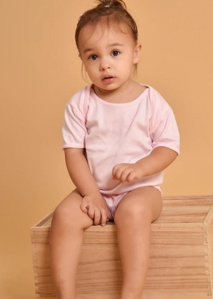A Model Wearing Multicolor Organic Cotton 3-Pack Short Sleeve Organic Bodysuits - Swan, Cherry Blossom Pink And White, curated by Only Ethikal