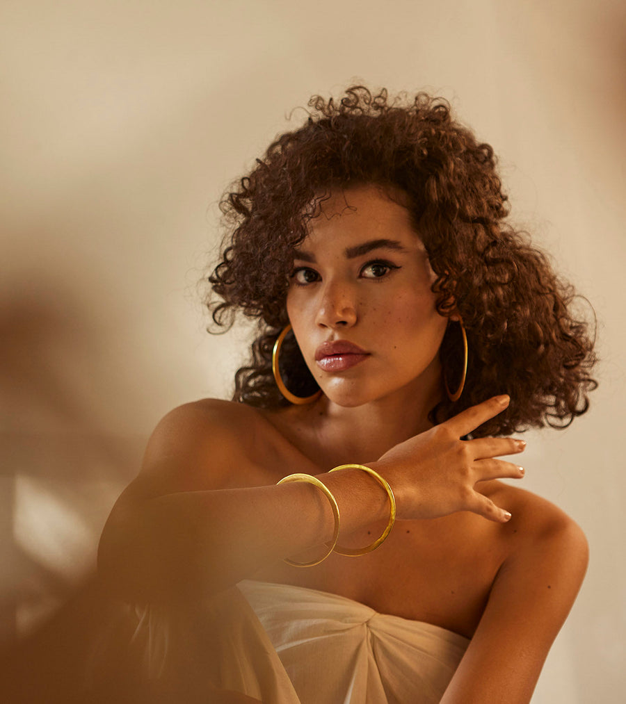 A Model Wearing Yellow 1 micron gold plated. Kaner Bangle, curated by Only Ethikal