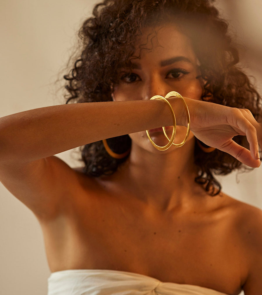 A Model Wearing Yellow 1 micron gold plated. Kaner Bangle, curated by Only Ethikal