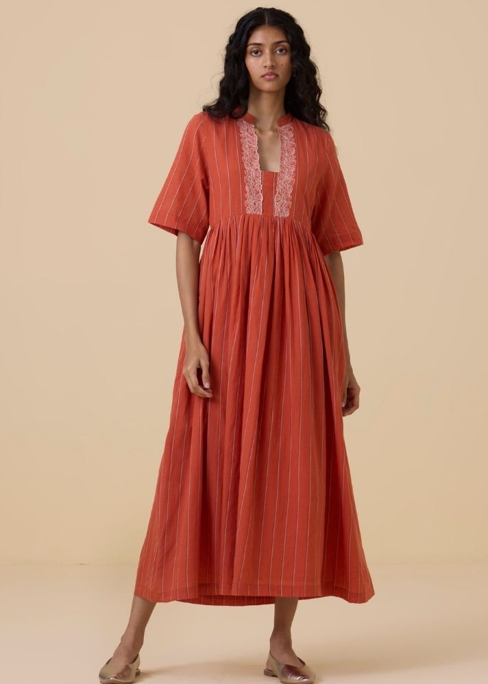 A Model Wearing Orange Handwoven Cotton Sabah Orange Cotton Striped Midi Dress , curated by Only Ethikal