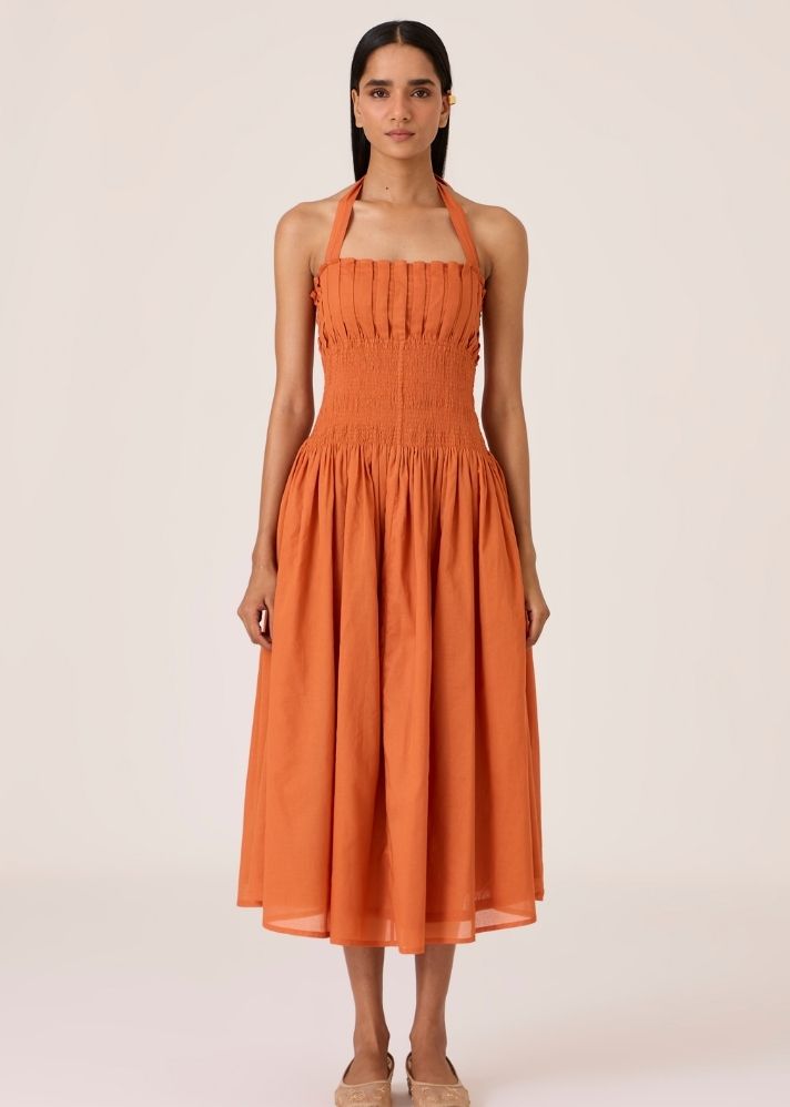 A Model Wearing Orange Organic Cotton Aisha Apricot Pleated Midi Dress , curated by Only Ethikal