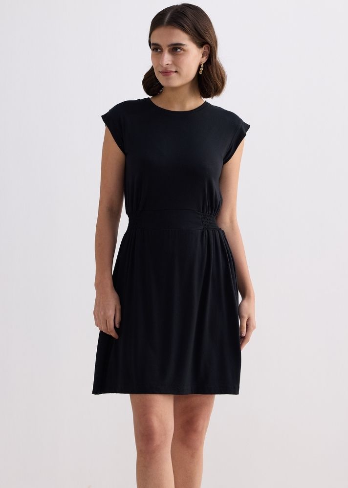 A Model Wearing Black Modal Short Dress With Smocking Side Detail In Black
, curated by Only Ethikal