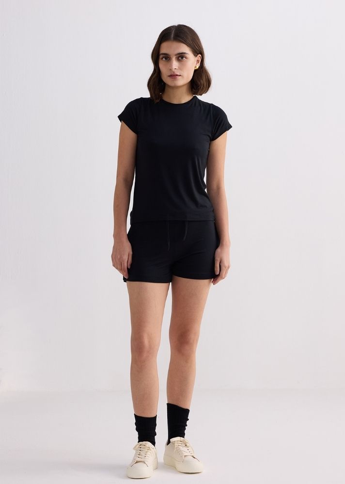 A Model Wearing Black Modal Essential Short Sleeve Tee In Black, curated by Only Ethikal