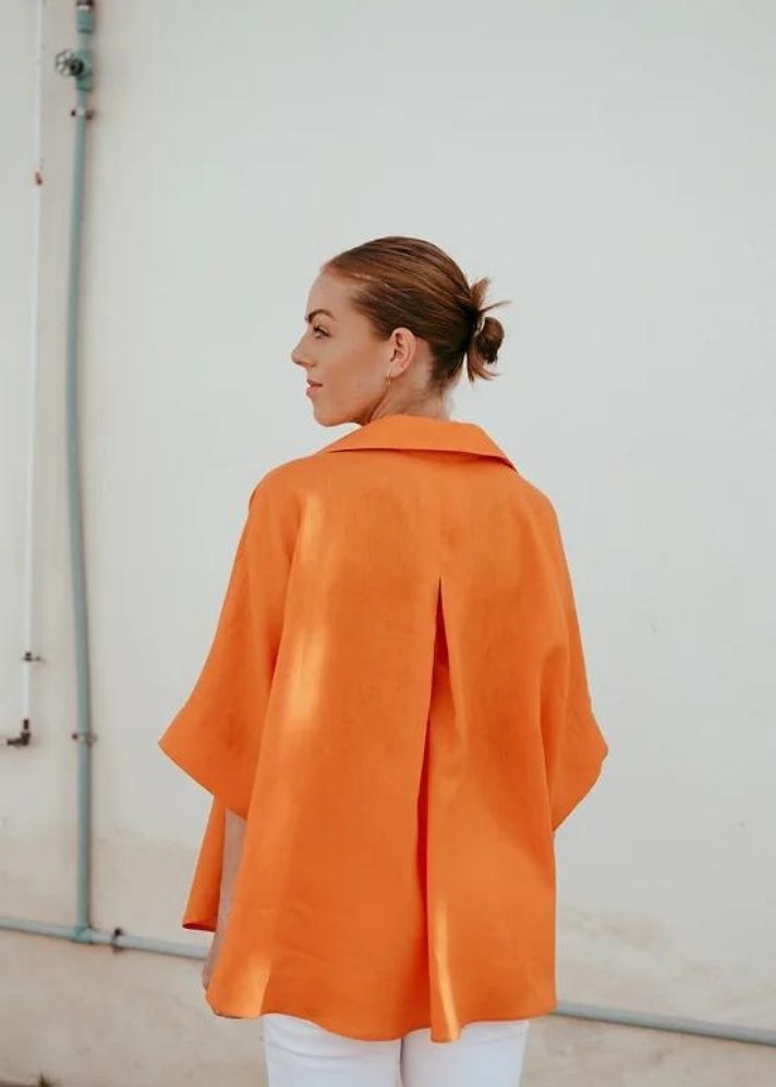 A Model Wearing Orange Linen Birds Of Paradise Shirt, curated by Only Ethikal