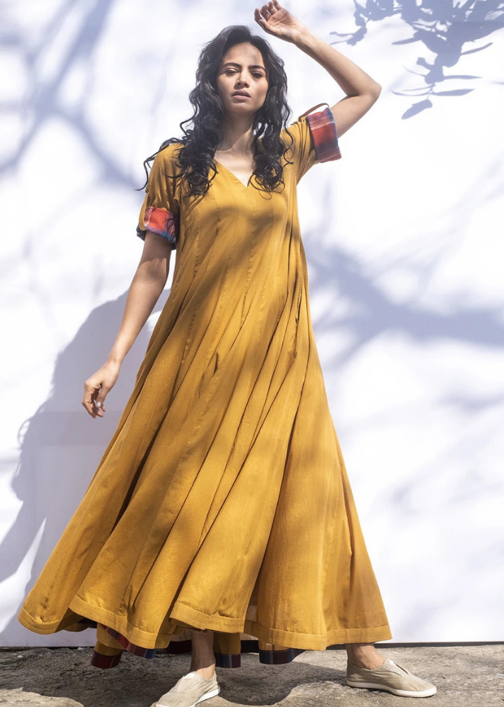 young woman wearing Indian style Ochre gown made of sustainable materials curated by onlyethikal