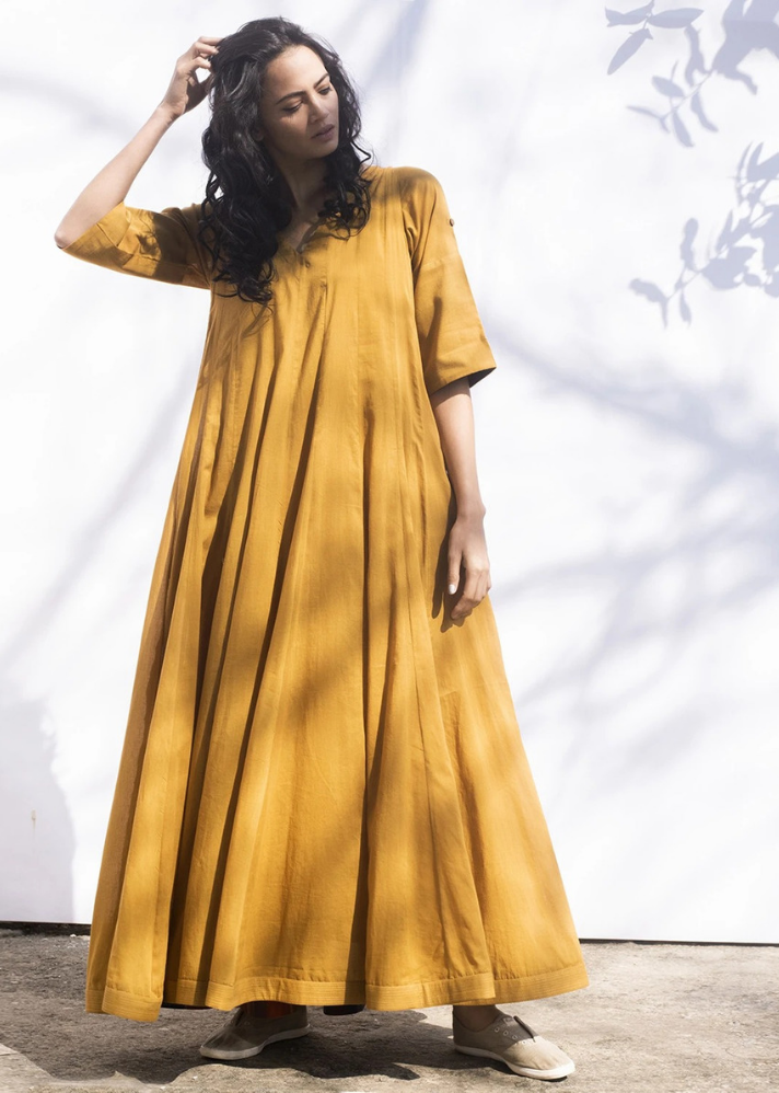 young woman wearing Indian style Ochre gown made of sustainable materials curated by onlyethikal