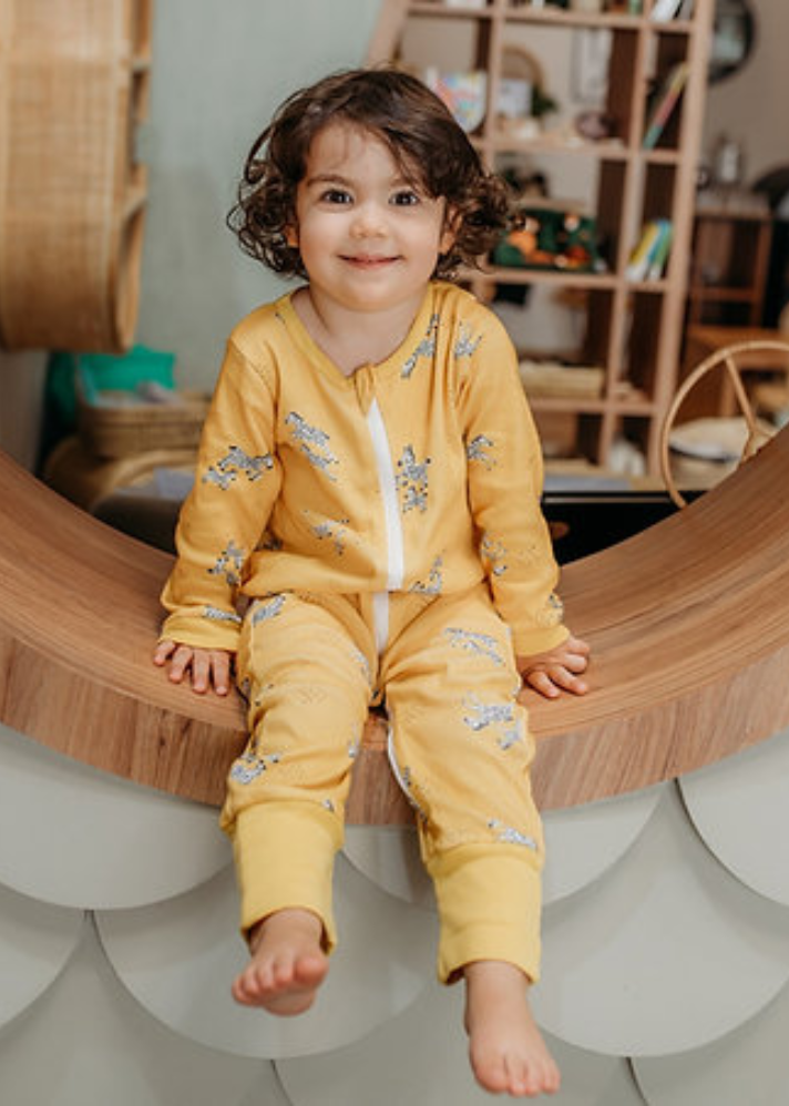 A Model Wearing Yellow Organic Cotton Zoe Zipup Organic Sleepsuit , curated by Only Ethikal