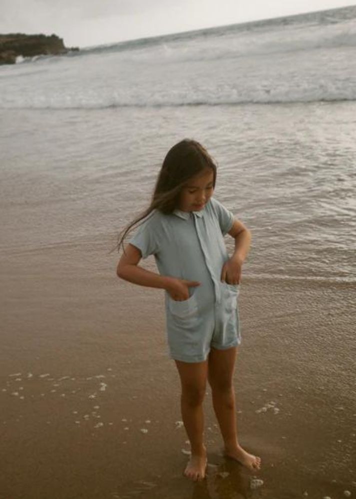 A Model Wearing Blue Organic Cotton Birch Romper in Sleepy Blue, curated by Only Ethikal