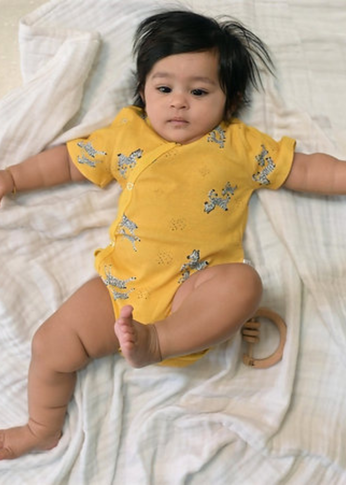 A Model Wearing Yellow Organic Cotton Zoe Organic Kimono Style Bodysuit , curated by Only Ethikal
