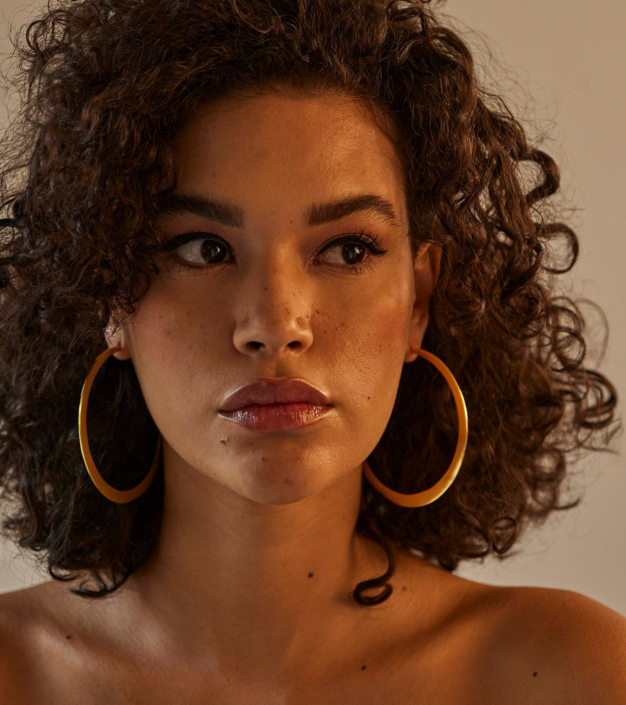 A Model Wearing Yellow 1 micron gold plated. Roohi Ear Hoops, curated by Only Ethikal