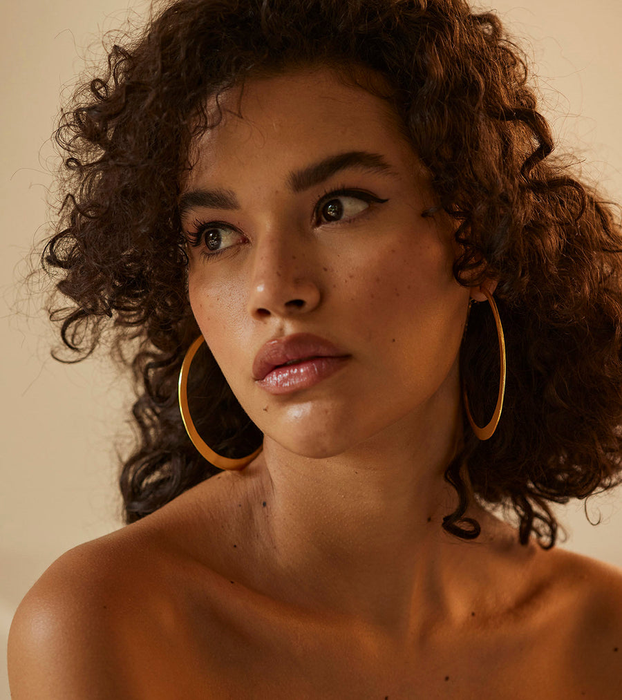 A Model Wearing Yellow 1 micron gold plated. Roohi Ear Hoops, curated by Only Ethikal