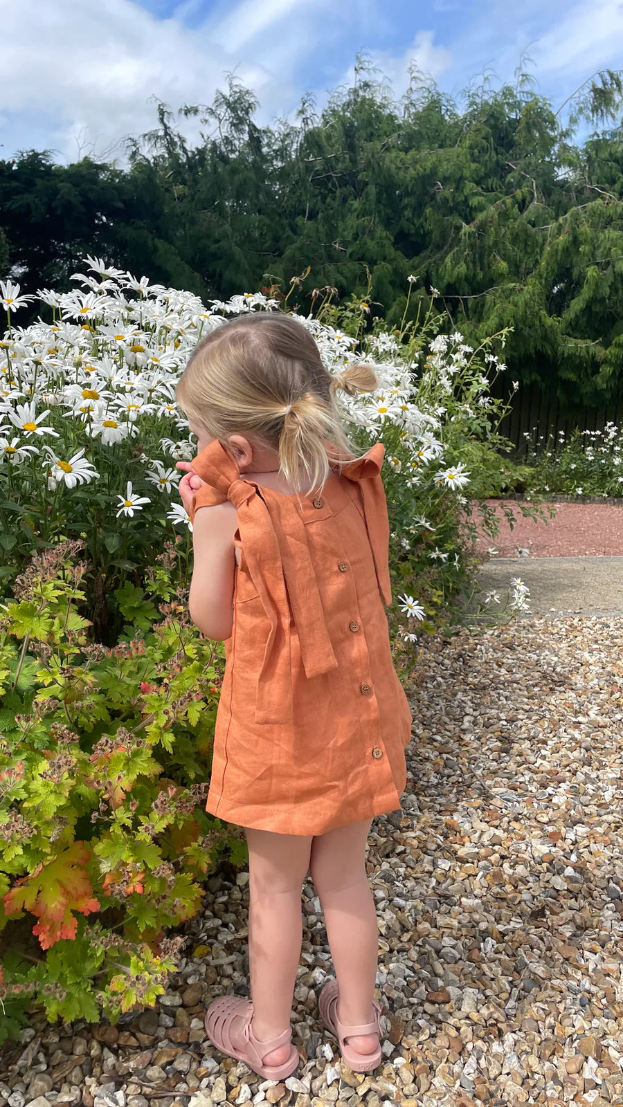 A Model Wearing Orange Linen Cinnamon Back Buttoned Dress, curated by Only Ethikal