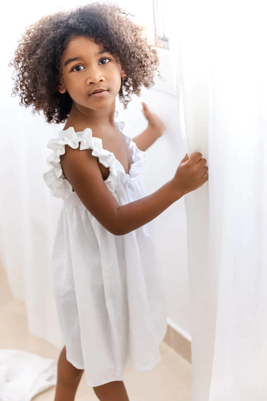 A Model Wearing White Linen Elenie Linen Dress , curated by Only Ethikal