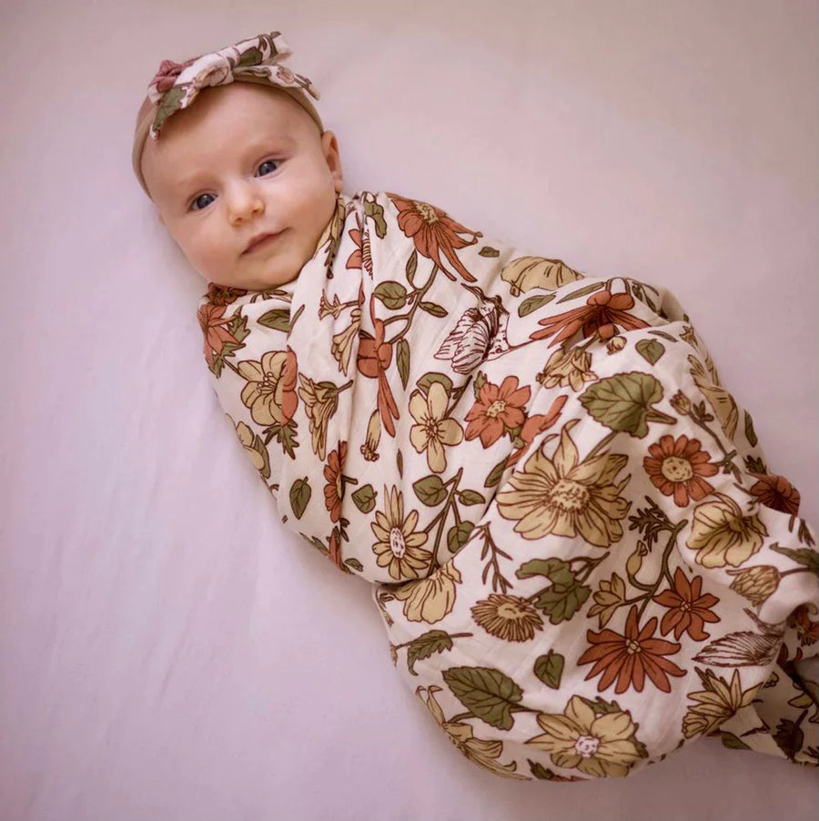 A Model Wearing Beige Pure Cotton Floral swaddle blanket/beanie and headbow, curated by Only Ethikal